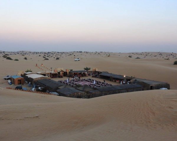 A desert camp seen frrom a dune