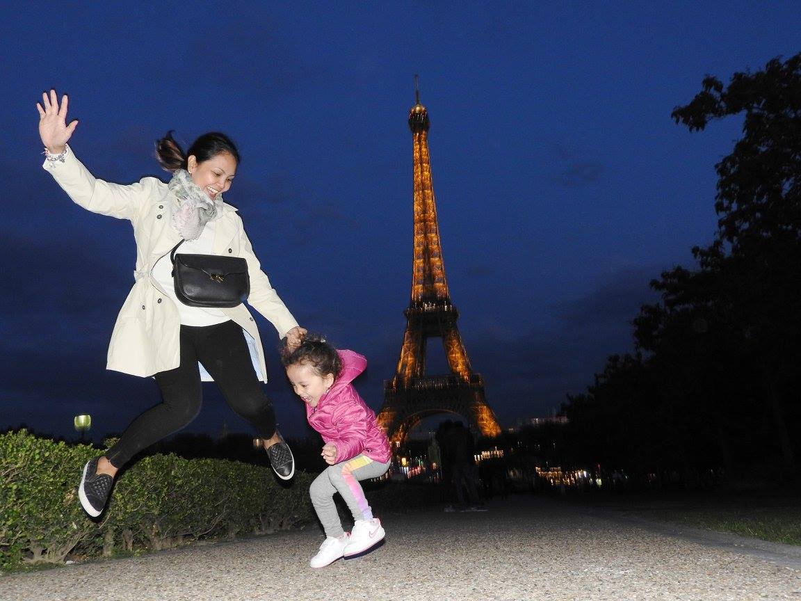 Lara and Mom at the Eiffel Tower by night. Lara is the world's youngest travel blogger.